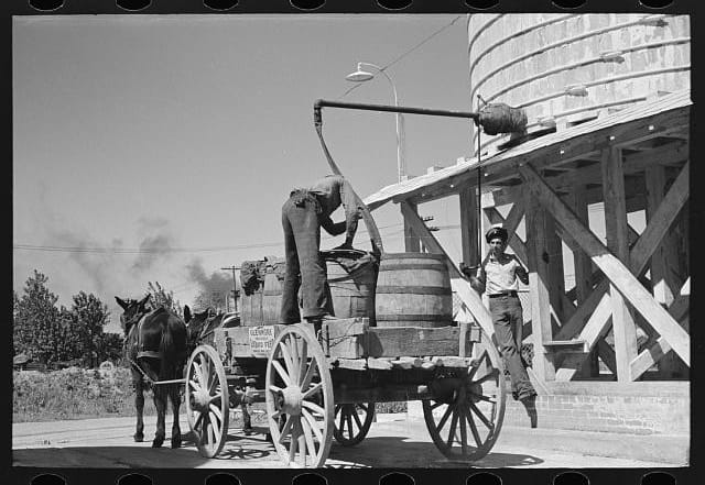 Farmers used to load feed by hand; now they use livestock feed management apps to help them tend their herds
