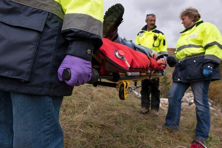 Medics carry worker on stretcher