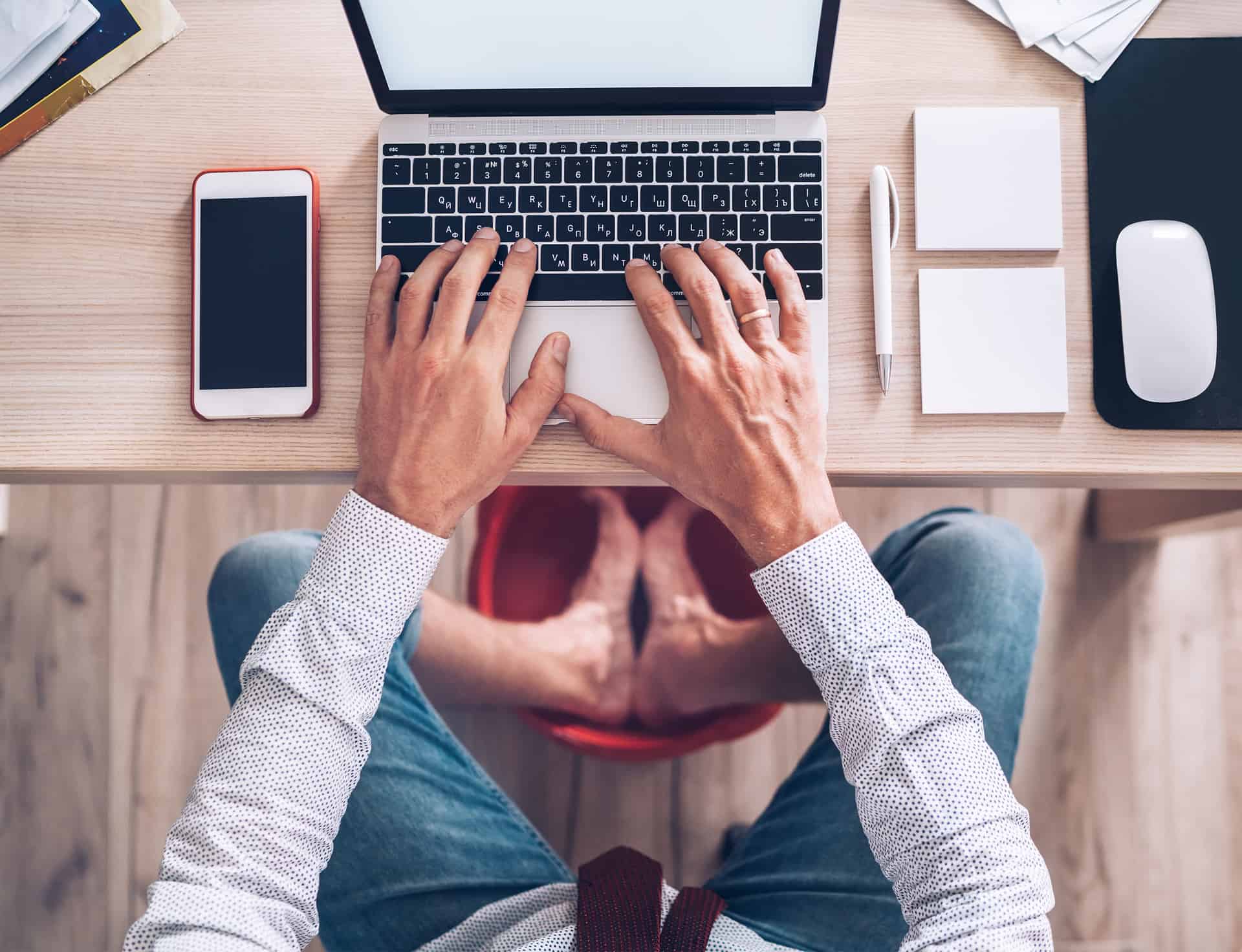 Man getting comfortable in a home-office setup - tips for working remotely & productively from home