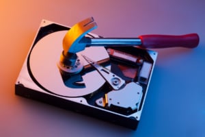 Image of hammer crushing disk drive to illustrate data destruction